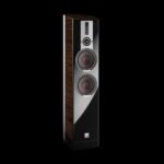 Tall floor-standing speaker with dark wood veneer sides and a glossy black front, featuring two large drivers and a tweeter in a vertical arrangement.